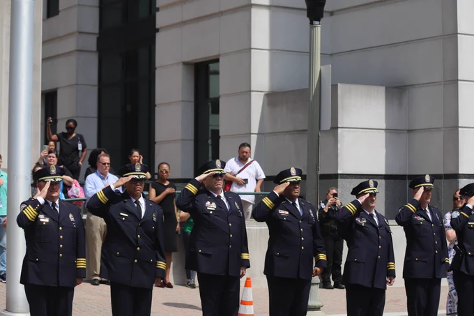 ACPD Executive Staff standing in a line and saluting.