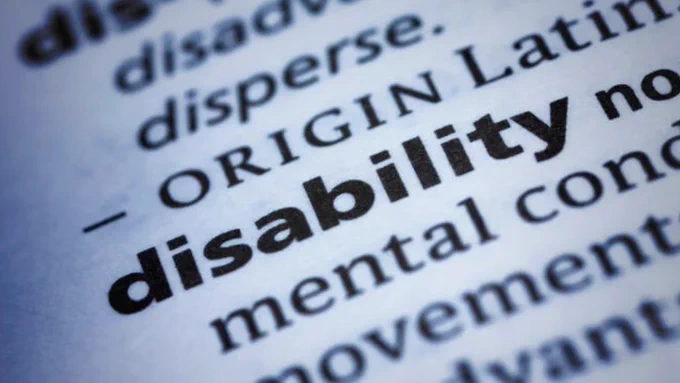 A close-up photo of a dictionary entry for the word "disability."