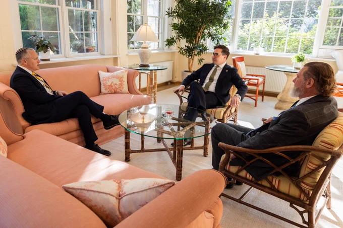 Photo featuring A/S Haines sitting and speaking.