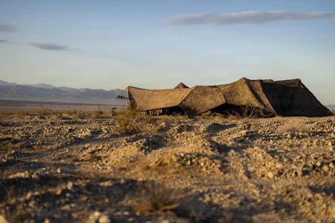 U.S. Marines assigned to Battalion Landing Team 2/4, 13th Marine Expeditionary Unit, conceal an M777 howitzer prior to executing a fire mission during unit-level training at Marine Corps Air Ground Combat Center Twentynine Palms, California, May 28, 2026. Unit-level training allows the artillery battery to hone fundamental skills and fire-direction procedures, forging a lethal and cohesive team prepared to provide critical fire support for the 13th MEU during complex and austere operations. (U.S. Marine Corps photo by Sgt. Mary Jenni)\n\n