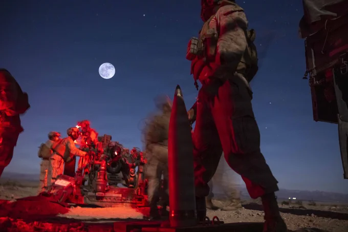 U.S. Marines assigned to Battalion Landing Team 2/4, 13th Marine Expeditionary Unit, prepare to fire an M777 howitzer in support of a fire mission during unit-level training at Marine Corps Air Ground Combat Center Twentynine Palms, California, May 31, 2026. Unit-level training allows the artillery battery to hone fundamental skills and fire-direction procedures, forging a lethal and cohesive team prepared to provide critical fire support for the 13th MEU during complex and austere operations. (U.S. Marine Corps photo illustration by Sgt. Mary R. Jenni) (This image was made in camera using double exposure with a Canon EOS R.)\n\n