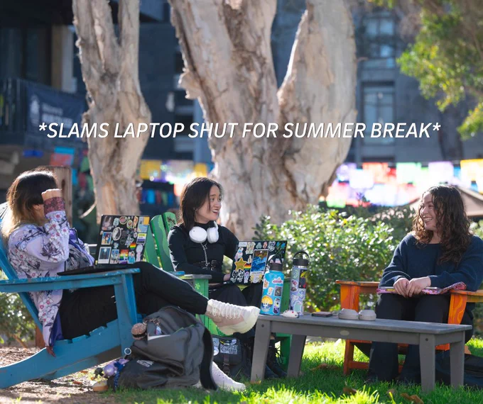 Three individuals sit outdoors on colorful chairs, engaged in conversation. Bold text above them says, "*SLAMS LAPTOP SHUT FOR SUMMER BREAK*".