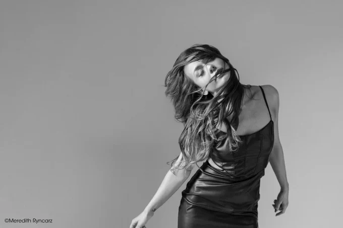 A woman with her hair in front of her face. Copyright Meredith Ryncarz.