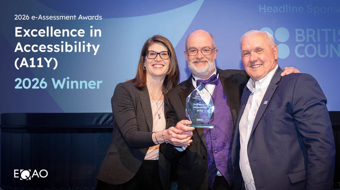 Three people are standing together, smiling and holding a glass award. The background displays the text "2026 e-Assessment Awards," "Excellence in Accessibility (A11Y) 2026 Winner," and logo for EQAO.