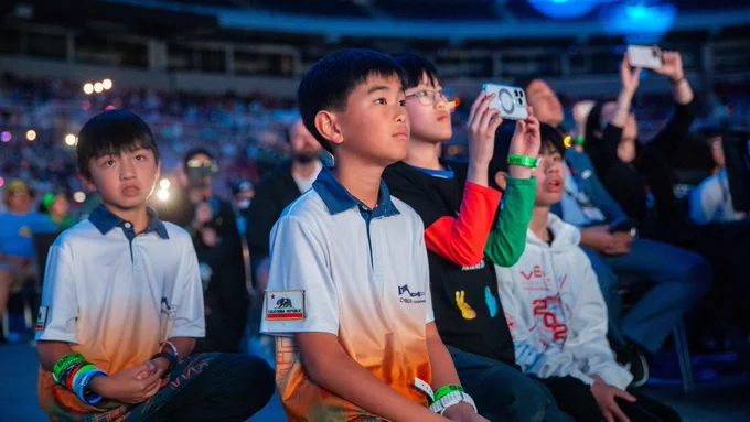 A group of students watching intently as VEX IQ Robotics Competition: Level Up is revealed at VEX Worlds 2026.