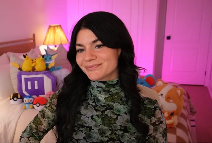 dark haired girl in floral printed turtleneck and pink backdrop