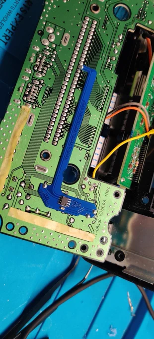 Blue quick-solder board (QSB) soldered directly onto a Sega 32X PCB for the switchless auto-hertz PAL/NTSC region mod.