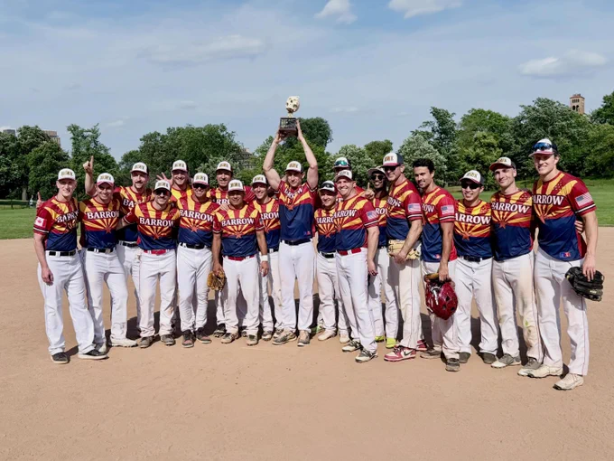 Barrow neurosurgery residents and faculty pose with the championship trophy. They are wearing matching jerseys that say \"Barrow\" and have a pattern of the Arizona state flag. 
