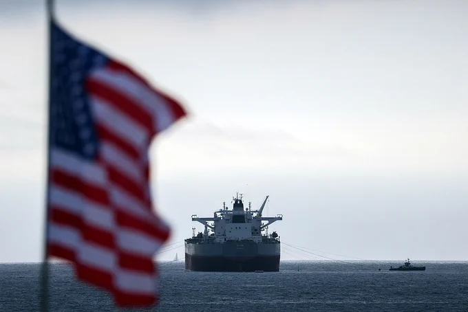 The image shows the crude oil tanker “CHIOS” moored near the shore in the waters off the Chevron El Segundo Refinery in El Segundo, California, on March 4, 2026, with an American flag waving in the wind. (Patrick T. Fallon/AFP via Getty Images)