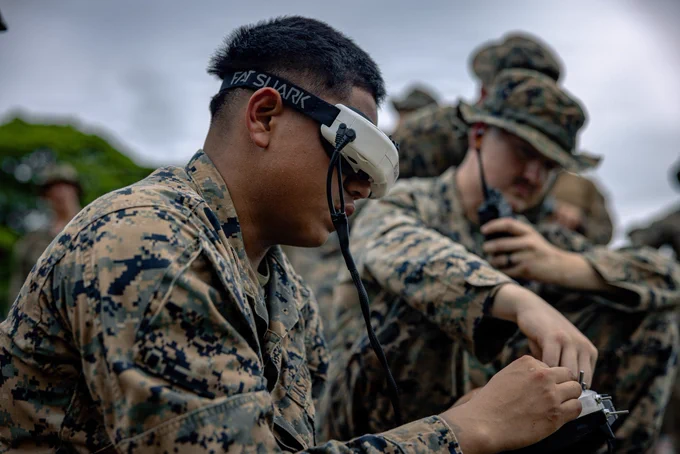 U.S. Marine Corps Lance Cpl. Juan Peragine, left, an attack drone operator with 3rd Light Armored Reconnaissance Battalion, currently forward deployed with 4th Marine Regiment, 3rd Marine Division as part of the Unit Deployment Program, operates the Neros Archer during a live-fire range on Camp Schwab, Okinawa, Japan, May 28, 2026. The range was conducted to familiarize Marines from 2nd Battalion, 8th Marine Regiment, 3rd Battalion, 7th Marine Regiment, and 3rd Light Armored Reconnaissance Battalion on the Neros Archer drone. Peragine is a native of Florida. (U.S. Marine Corps photo by Cpl. Joaquin Dela Torre)
