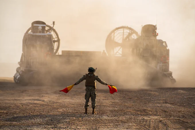 A U.S. Navy Sailor assigned to Assault Craft Unit (ACU) 5, marshals Landing Craft, Air Cushion (LCAC) 90, attached to ACU 5, during an in-stream onload at Marine Corps Base Camp Pendleton, California, June 8, 2026. The in-stream onload transported personnel and equipment to Wasp-class amphibious assault ship USS Essex (LHD 2) as part of the 15th Marine Expeditionary Unit’s embarkation process for RIMPAC 2026. Thirty-one nations, 36 surface ships, 5 submarines, 15 national land forces, more than 206 aircraft and 25,000 personnel are participating in RIMPAC in and around the Hawaiian Islands, June 24 to July 31. The world’s largest international maritime exercise, RIMPAC provides a unique training opportunity while fostering and sustaining cooperative relationships among participants critical to ensuring the safety of sea lanes and security on the world’s oceans. RIMPAC 2026 is the 30th exercise in the series that began in 1971. (U.S. Marine Corps photo by Cpl. Kenneth Twaddell)
