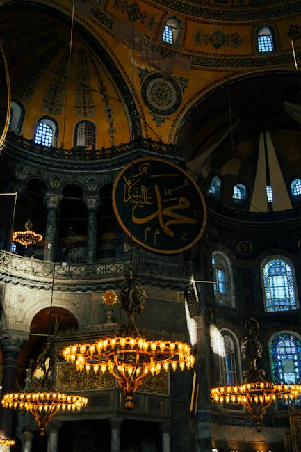 Interior view of Hagia Sophia showcasing ornate chandeliers and intricate architecture under soft light.