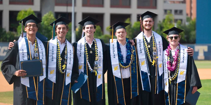 UC San Diego men's volleyball's six graduating seniors in their graduation attire