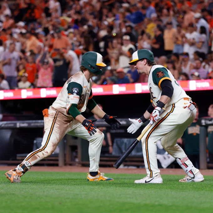 Gunnar Henderson high-fives Adley Rutschman after Henderson's home run Friday night. They wear the Orioles City Connect uniforms.
(Photo: Alyssa Piazza/Major League Baseball)