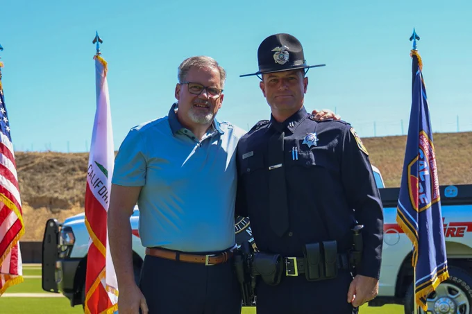 Fire Captain Roman standing after having his badge pinned.