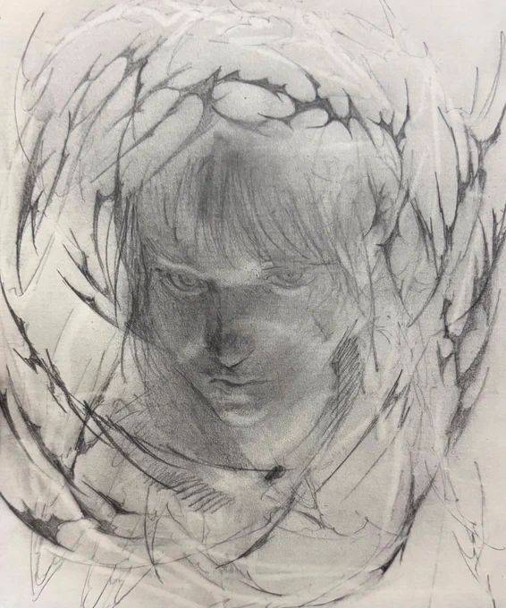 クロッキー帳にシャーペンで描かれたドローイング　画面真ん中に人物の顔が浮かび上がり、顔の周りにはトライバル調の図像が描かれている