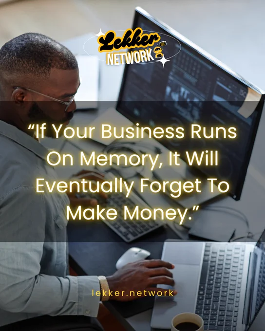 A professional sitting at a desk with a motivational business quote overlay. The mood is reflective and serious.