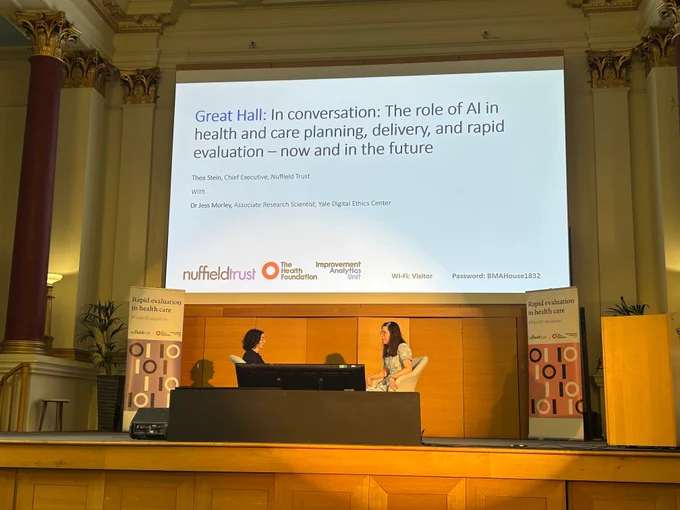 Thea Stein and Jess Morley on stage at the Rapid Evaluation Conference.