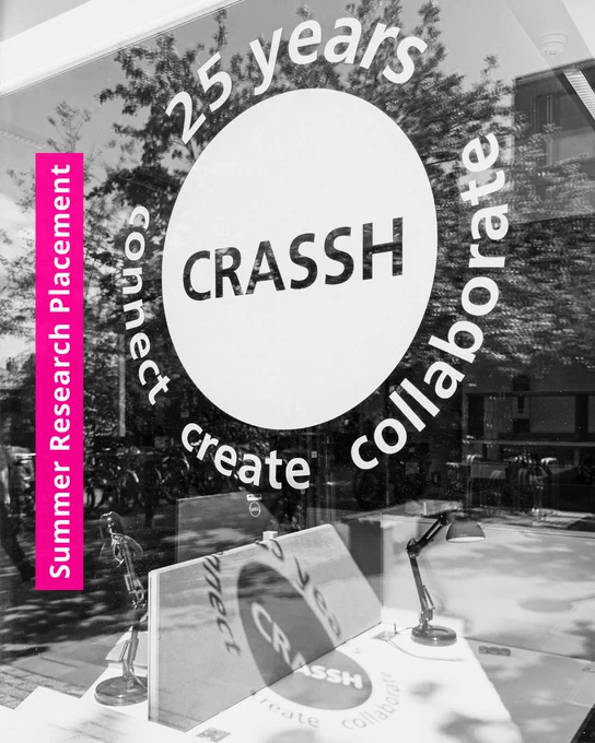 Summer Research Placement at CRASSH. Photo of a CRASSH window sticker casting a shadow on a desk.