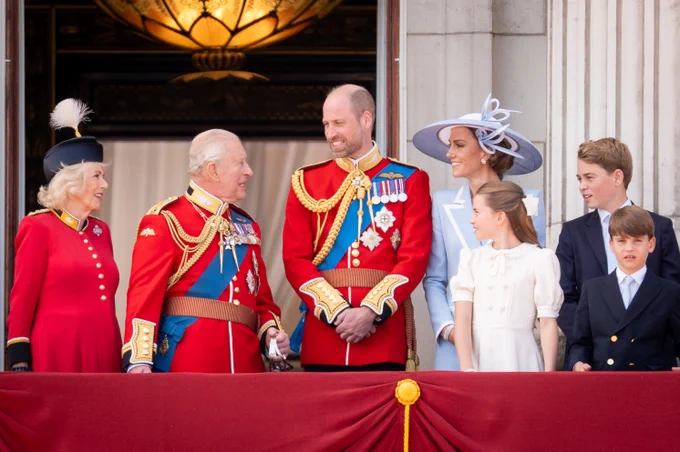 Queen Camilla, King Charles, Prince William, Kate Middleton, Prince George, Prince Louis and Princess Charlotte stand on the balcony at Buckingham Palace