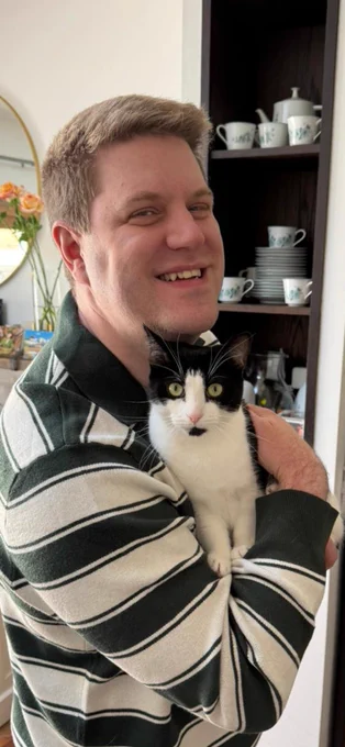 Peter holding Scout the cat in his arms