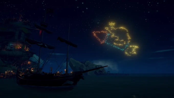 A ship sits next to an Outpost at night as a firework of a rat riding a rocket and wearing a crown lights up the sky.