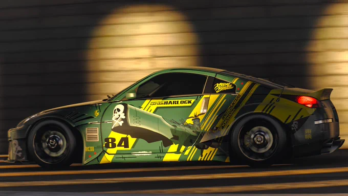 A custom sports car with vibrant green and yellow graphics displayed on its side, featuring the number 84 and various decals, is driving through a dimly lit tunnel.
