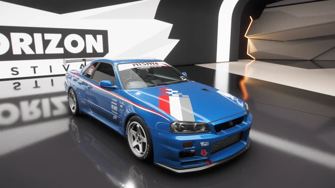 A blue Nissan sports car with racing decals and logos is displayed in a modern showroom. The car features white and red stripes, and has visible branding such as Nissan. The background includes bold, geometric patterns and the word "Horizon" in large letters.