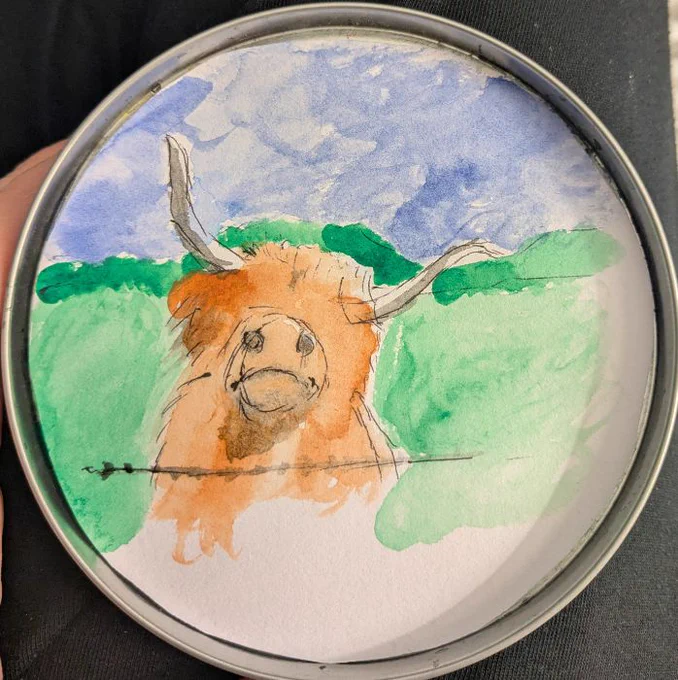 hairy cow, tan. head tilted sideways. long horns