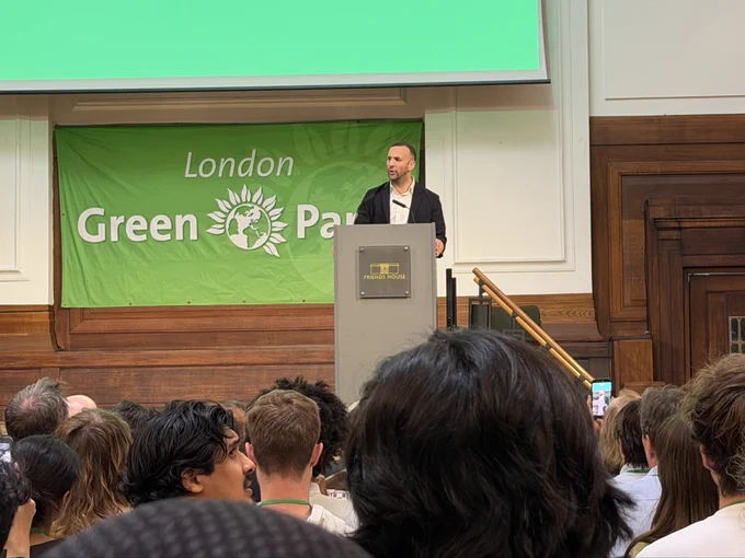 Zack Polanski speaking on stage at London Green Party Conference