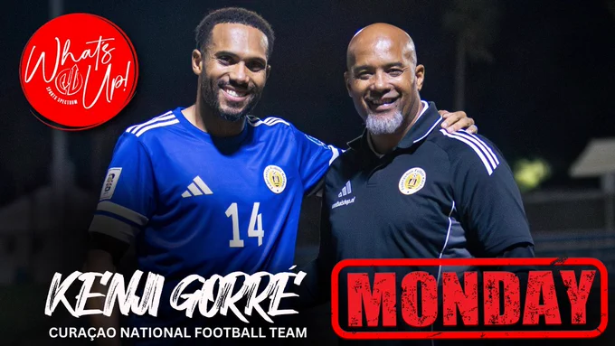 Two men from the Curaçao National Football Team, one in a blue jersey and the other in a black polo, smiling at the camera. Text overlays promote the team and day of the week.