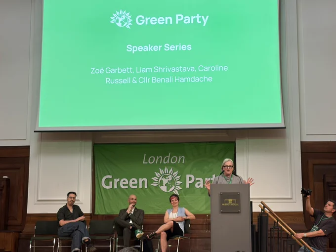 Caroline Russell speaking in front of a London Green Party banner