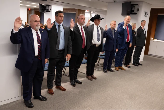 Eight U.S. Marshals getting sworn in.