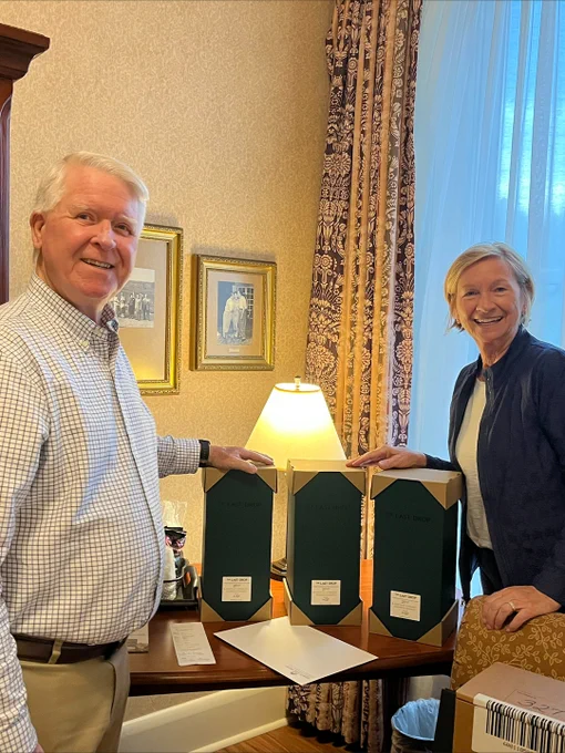 Two people smiling with hands on 3 bottles of  Release No. 37: The Last Drop 27 Year Old Kentucky Straight Bourbon from Buffalo Trace Distillery. 