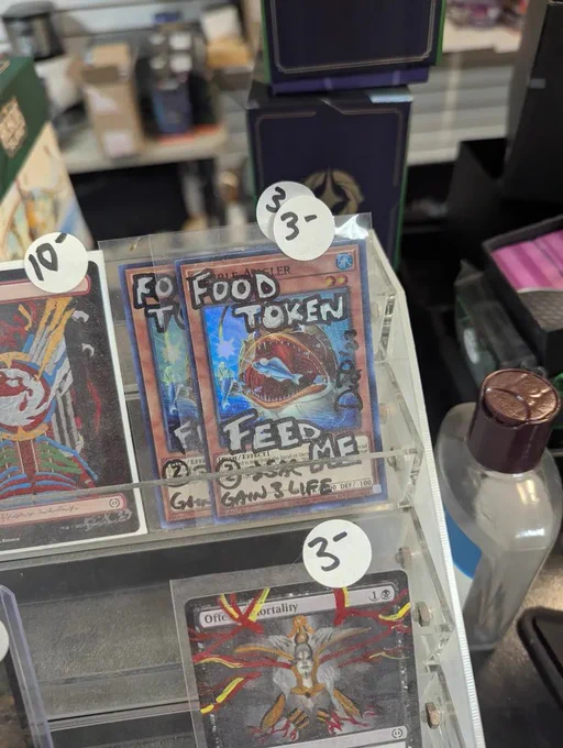 A copy of the yugioh card nimble angler drawn on with marker. It is marked with text designating it as a food token from mtg 