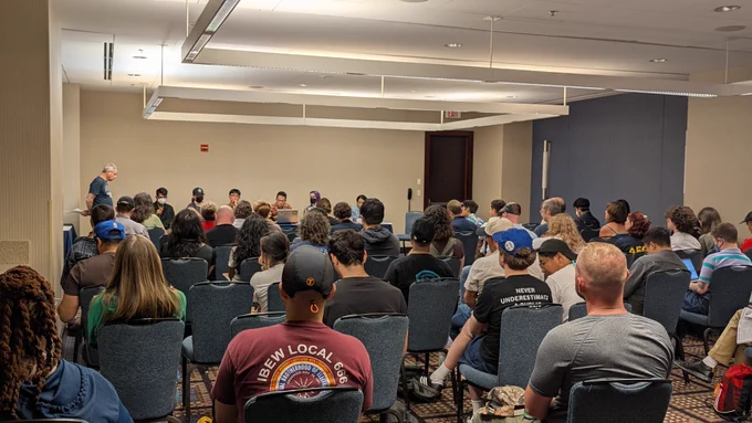 Conference attendees at gather for a panel on "The Hidden Impacts of A.I.: Building Power In The Semiconductor Supply Chain" 