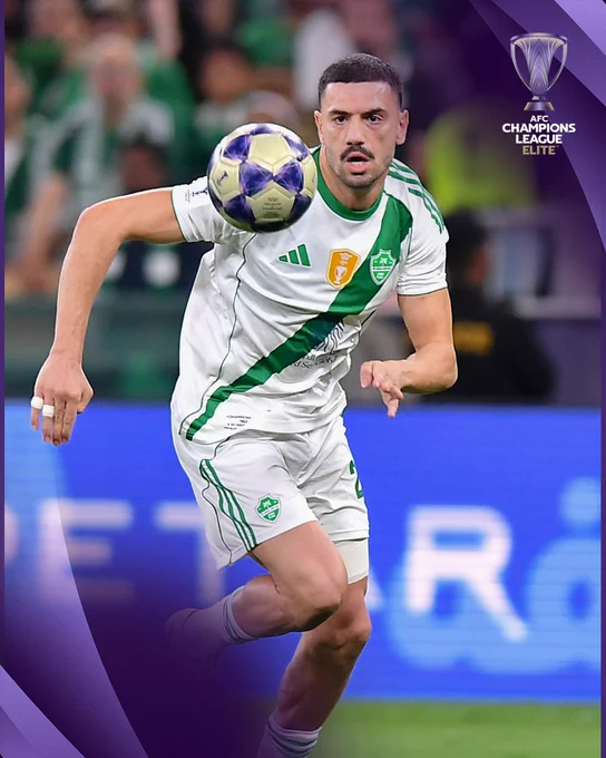 A player wearing a white and green soccer uniform is intensely focused on the ball during an AFC Champions League match. The image conveys dynamic action and competitive spirit, with a vivid purple overlay.