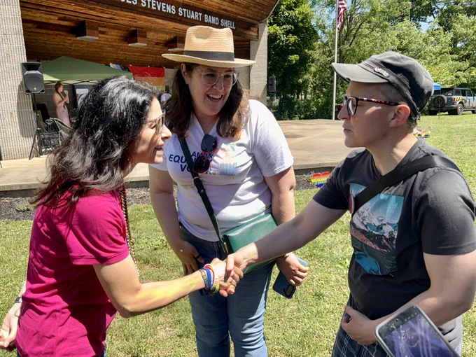 AG Nessel shakes hands with pride-goer