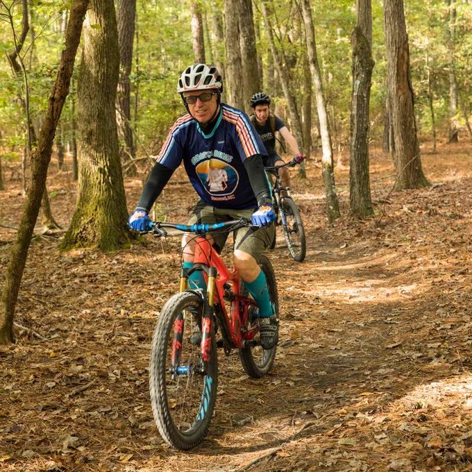 Bikers ride along a trail at Lake Crabtree County Park.