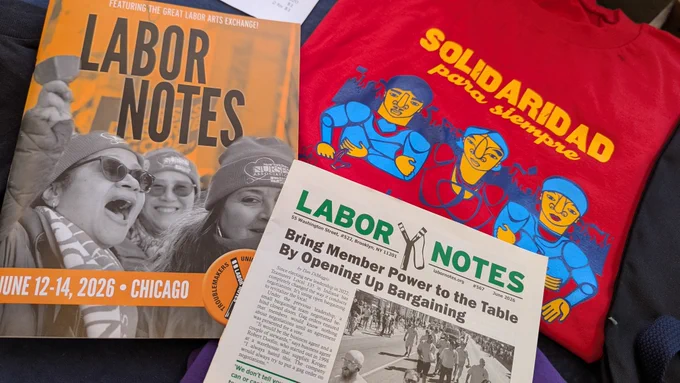 A copy of Labor Notes' June issue next to a program for the 2026 Labor Notes conference and a shirt reading "Solidaridad para siempre"