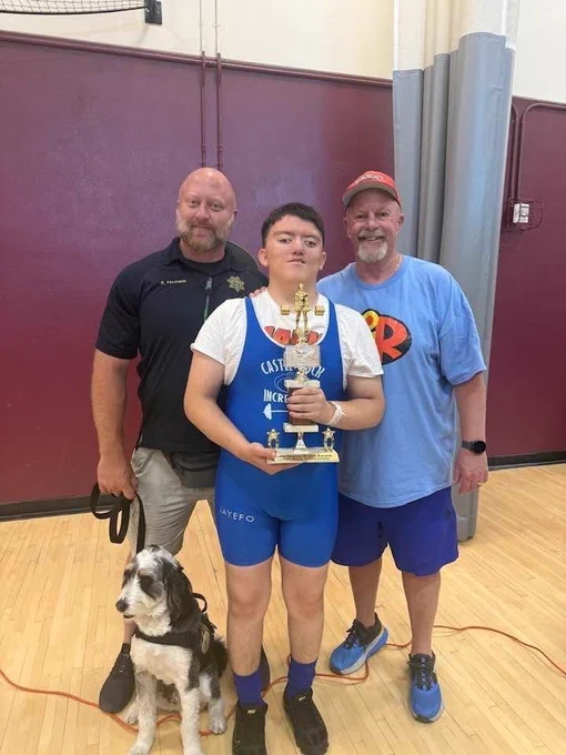 A member of the Douglas County Sheriff's Office is with a coach and an athlete from Special Olympics.