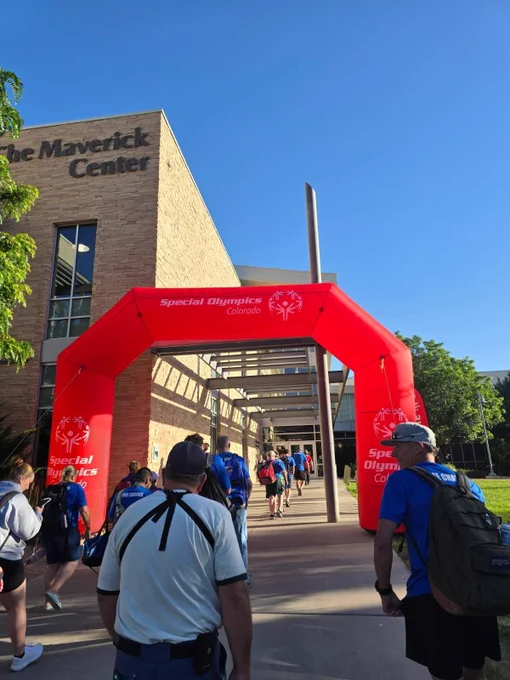 People walking into a Special Olympics event.