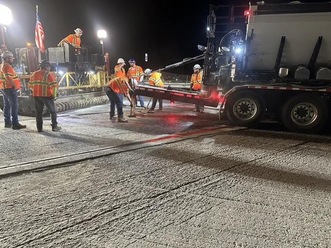 Workers work on a paving project.