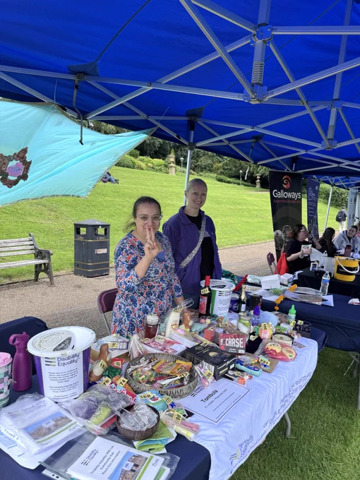 Charity stall with two people sat