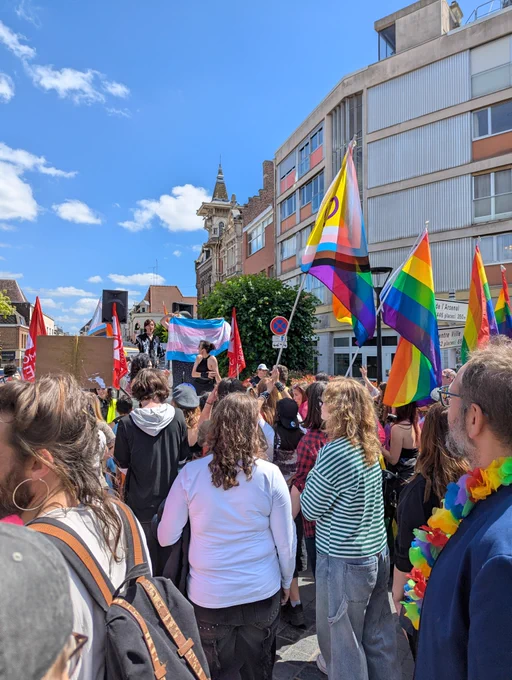 Pride de Valenciennes ce 13 juin 2026 avec plein de gens lgbt et alliés avec leurs drapeaux et un char rempli de personnes charismatiques.