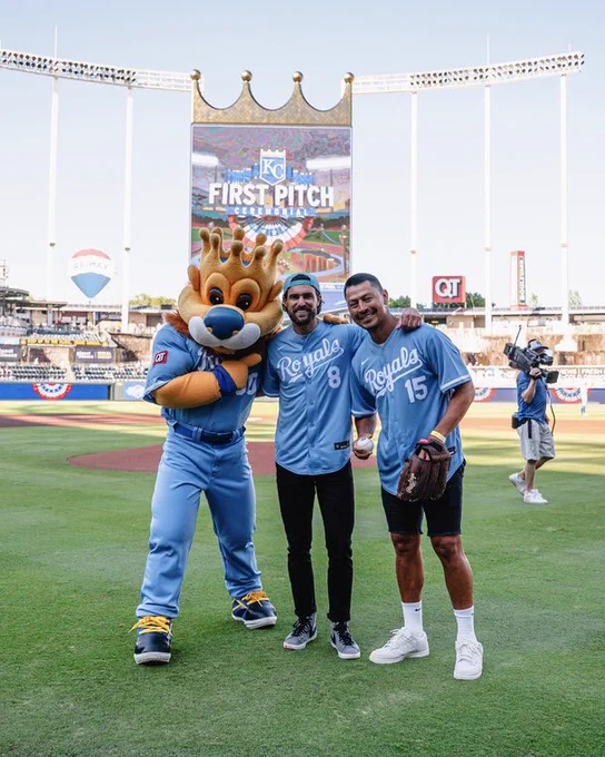 Graham Zusi and Roger Espinoza smile with Sluggerrr after throwing out the First Pitch at Kauffman Stadium. (Photo by Amy Kontras/Kauffman Stadium)