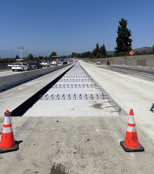 Lean concrete base covered with plastic bond breaker & dowel baskets. 