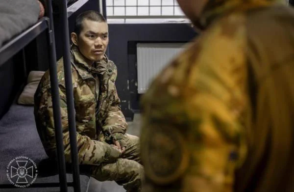 Ukraine's Security Service (SSU) releases photos claiming to have captured two Chinese nationals fighting for the Russian army. /EPA, Yonhap News Agency