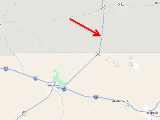 A red arrow points to a location on Arizona Route 87 near Winslow Arizona.