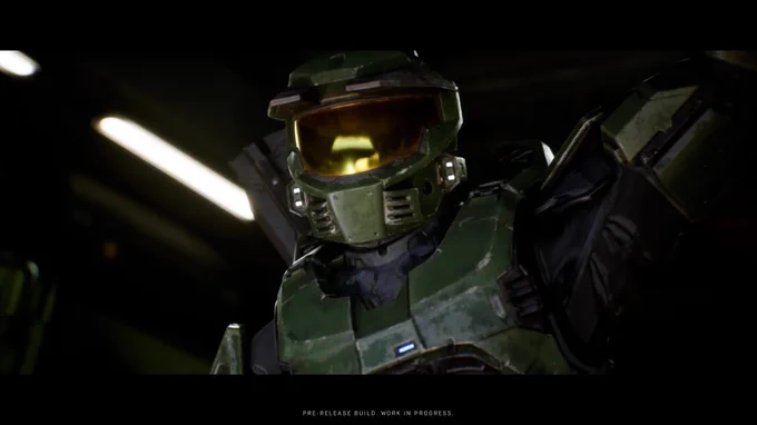 A close-up of Master Chief in a dimly lit environment with bright light sources in the background.